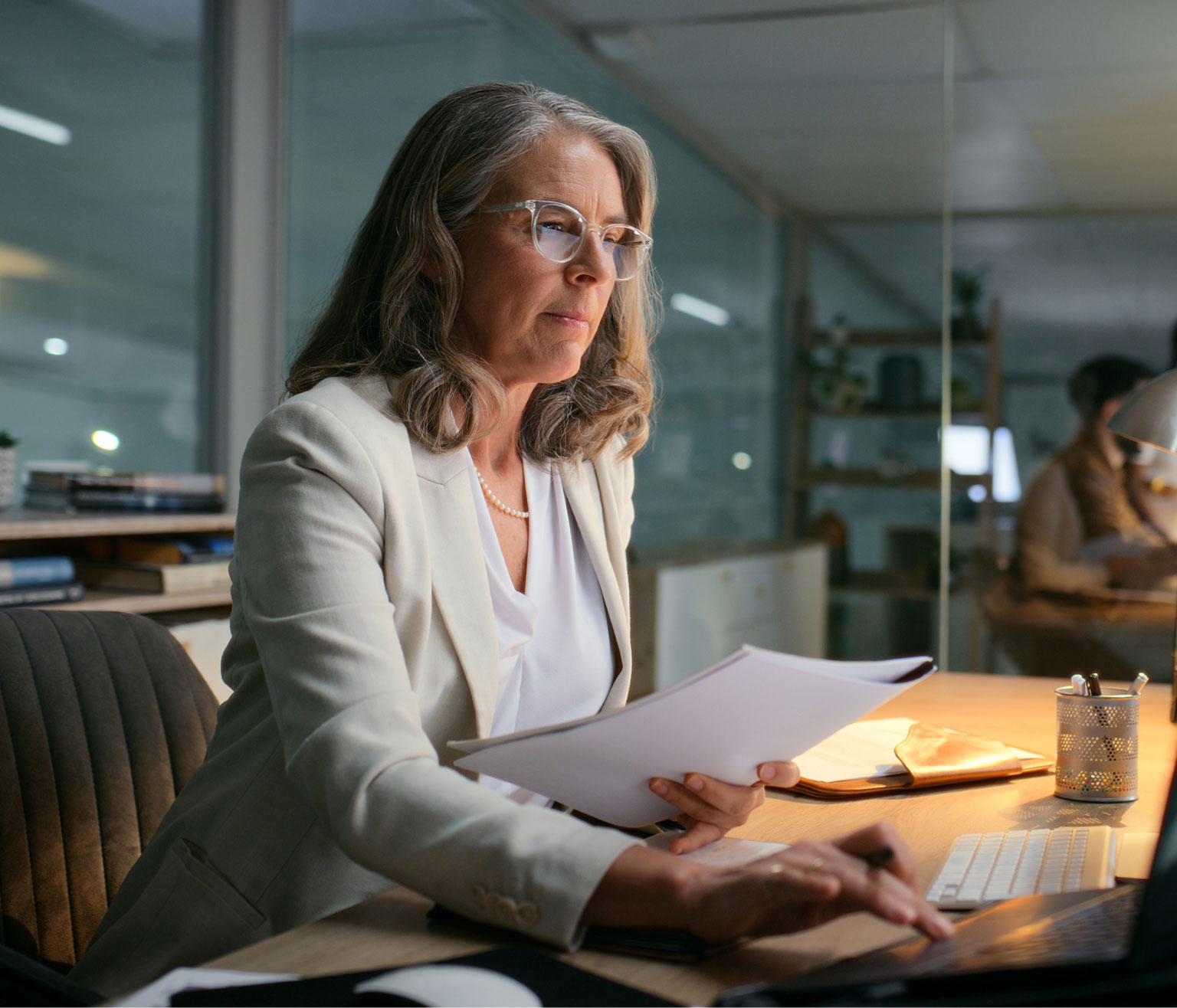 Woman sitting at a desk viewing her computer